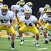 Michigan football players do stretching drills during warm ups at practice on Tuesday.  Melanie Maxwell I AnnArbor.com
